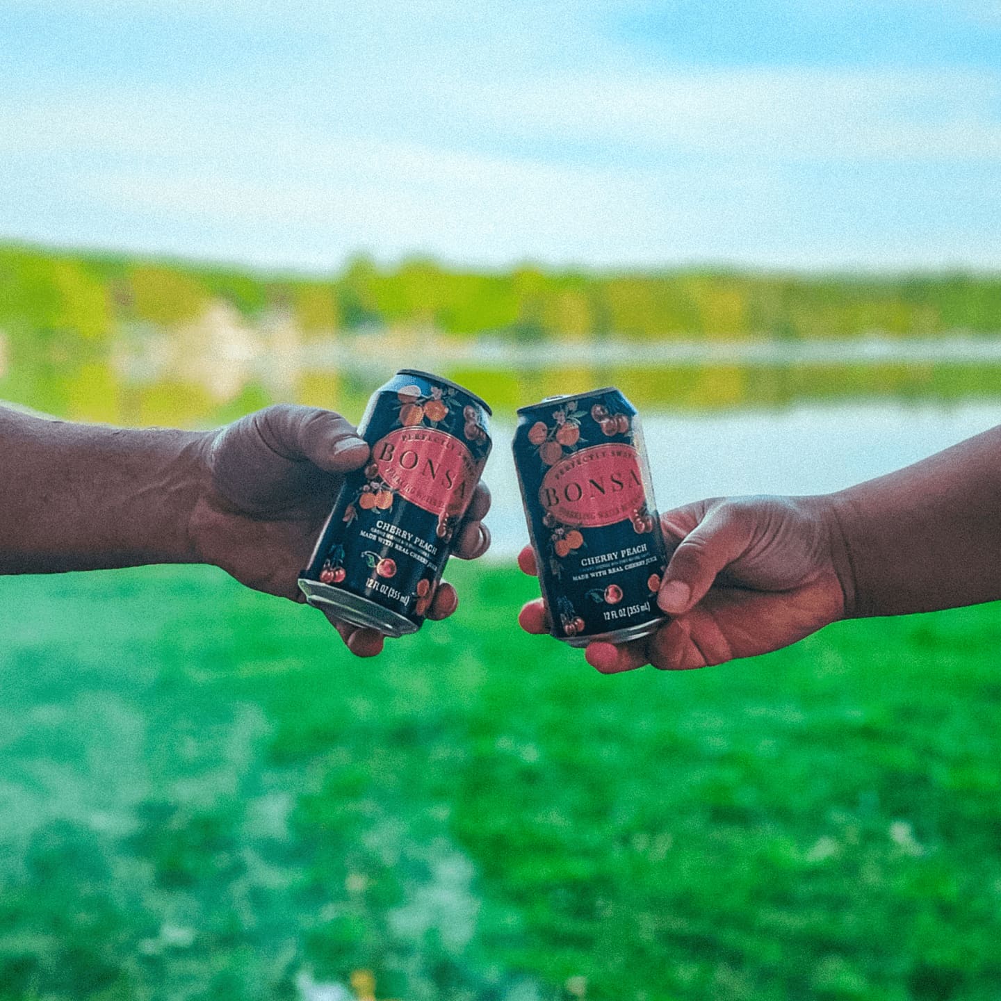 Cheers with two cans of Cherry Peach Bonsai